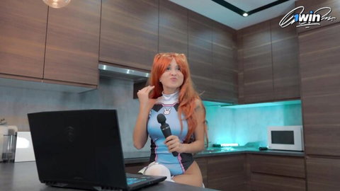 Redhead babe in skimpy blue cosplay holds blue wand dildo vibrator teasing in kitchen