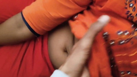 Man's fingers groping South Asian woman's exposed navel and belly in orange saree