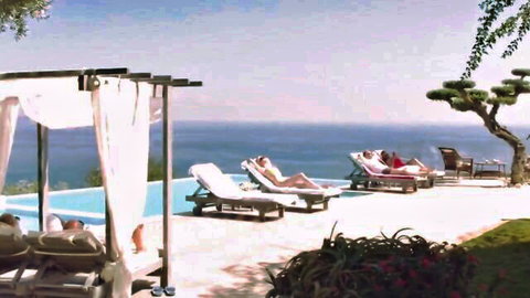 French beauty in bikini lounging poolside on sunny vacation
