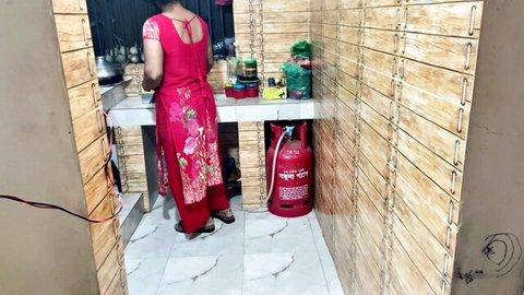Indian aunty in red dress viewed from behind in kitchen, teasing curves