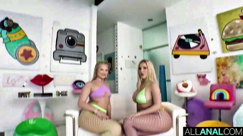 Two curvy blondes in skimpy bikinis and fishnet stockings posing seductively on chairs
