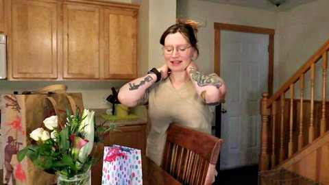Tattooed MILF smiles in casual top during birthday massage setup, POV