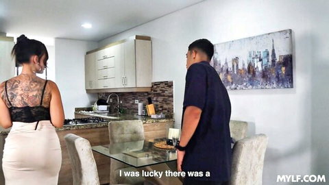 Tattooed MILF in tight skirt teases big ass at kitchen counter with guy behind her