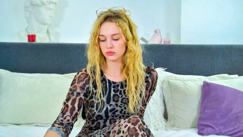 Blonde Miahowardss in sheer leopard print top, seductive pose on bed