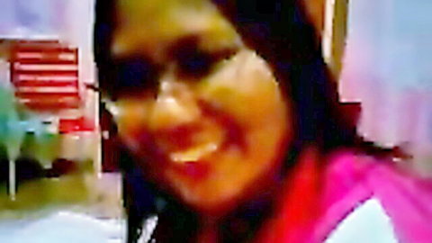 Smiling Malay girlfriend in glasses, pink top, long dark hair