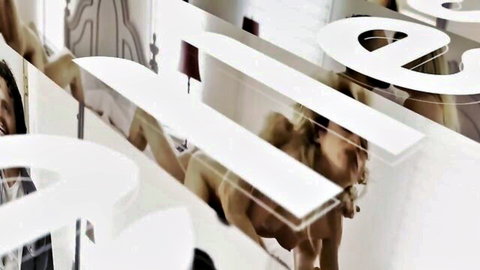 Nude athletic fair-skinned women with short red hair posing seductively behind large white PLEASE letters