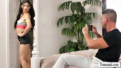 Brunette trans teen in striped crop top and tiny shorts poses teasingly as guy photographs her ass