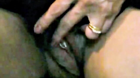 Close-up of mature woman's pussy fingered by hand with gold wedding ring