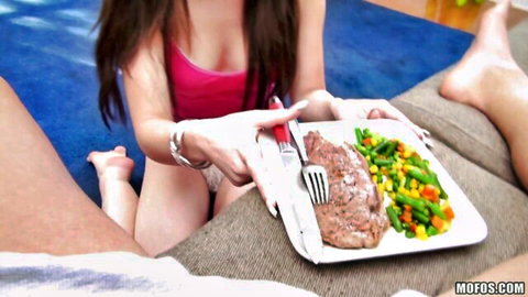 Lacy Channing in pink top feeding steak seductively to man