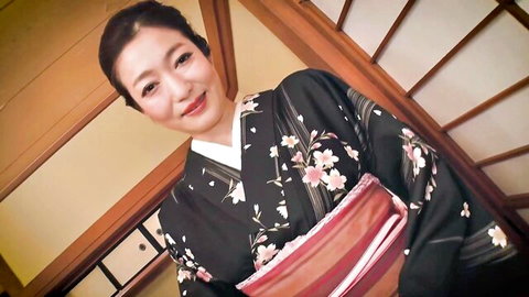 Ryu Enami in elegant black floral kimono, smiling seductively