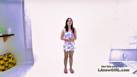 Kat Marie posing in pink top and shorts in studio before strapon ride