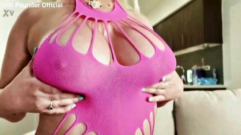 Jenna Starr in revealing pink fishnet top, cupping her huge breasts