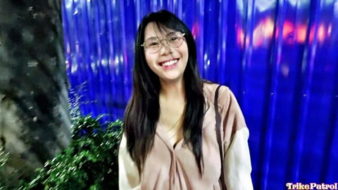 Kathryn Kaloka smiling in low-cut pink top, glasses, long hair in Trikepatrol