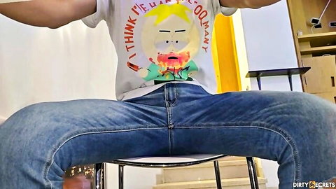 Muscular guy in South Park tee sits spread-legged in jeans, teasing homemade stepbro stepmom action