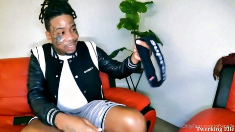 Elle in Supreme jacket and shorts, holding band, teasing birthday threesome