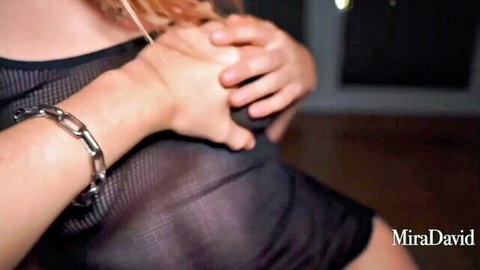 Redhead babe squeezing her big tits through sheer black mesh top in steamy POV tease