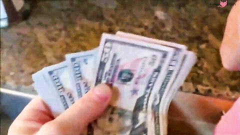 Hands holding stacks of cash, teasing big tits secret payoff