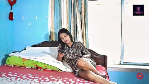 Sexy Indian stepsister in short dress lounging on bed, teasing vibe