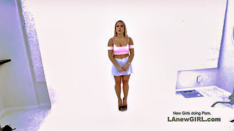 Rebecca Volpetti in pink crop top and white mini skirt audition pose