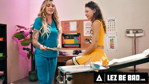Tattooed nurse Kendra Sunderland examines cheerleader Liz Jordan in lesbian seduction scene