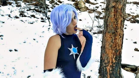 Blue-haired cosplay babe in sexy black top sucks finger seductively in snowy forest