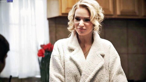 Blonde MILF in fluffy white robe smirks seductively in kitchen teasing stepson