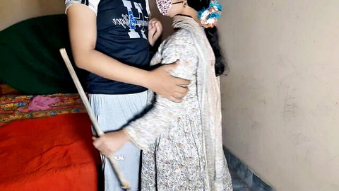 Desi Indian maid in floral dress embraced tightly from behind by man in homemade video