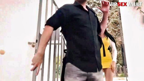 Lovenia Lux in sexy yellow dress with man at luxury outdoor gate casting