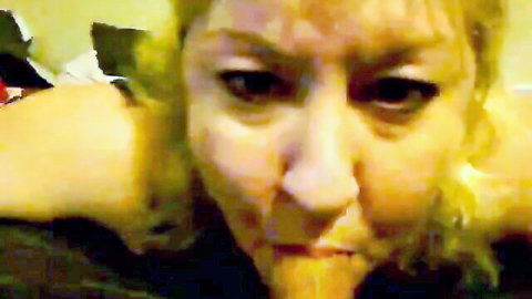 Mature blonde with thick cum dripping from open mouth after blowjob
