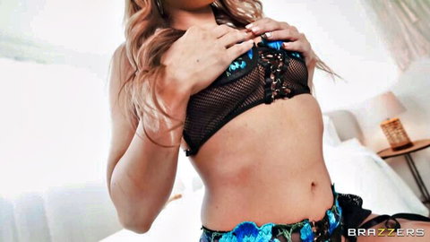 Blonde squeezes sheer black lace bra revealing perky tits and nipples in floral garter belt on bed