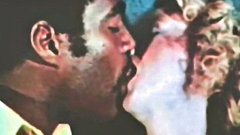 Vintage black man passionately French kissing blonde woman close-up