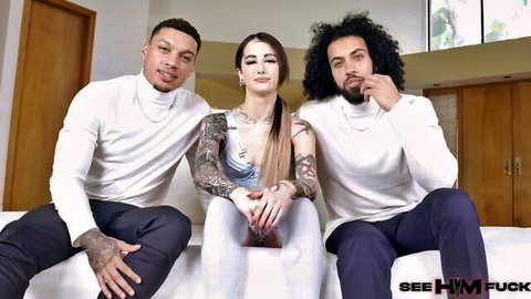 Tattooed brunette babe poses teasingly between two muscular black studs in See HIM Fuck threesome preview
