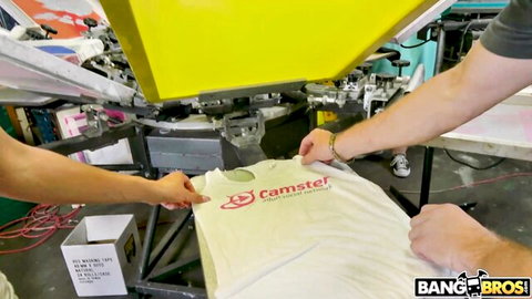 Workers screen printing Camster logo on white t-shirt in BangBros facility