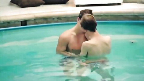 Two fit young men embracing intimately in pool, bareback gay action