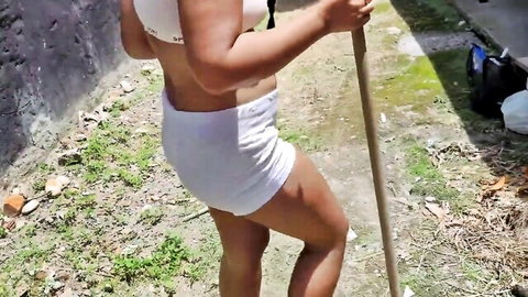 Curvy woman in tight white shorts showing juicy ass and thick thighs outdoors gripping long pole