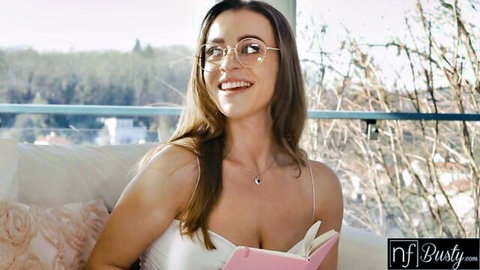 Busty Josephine Jackson in glasses, smiling with deep cleavage