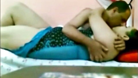 Curvy Egyptian amateur in blue dress embraced and kissed by partner in intimate scene