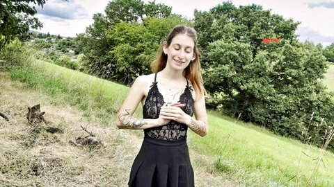 Redhead teen with big tits and tattoos in sheer black lace bralette and mini skirt smiling for outdoor selfie