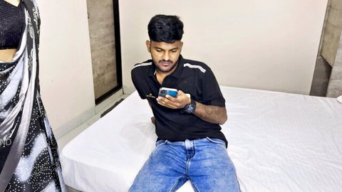 Indian dude on bed tempted by desi babe in sexy black saree, phone tease