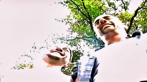 Interracial outdoor orgy thumbnail: two men smiling upward in wooded ecstasy