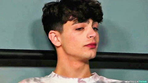 Hesitant young twink with curly hair in pastel shirt, side profile gaze