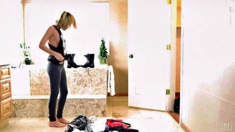 Blonde Emma Stoned in tank top and leggings, sensual dressing pose