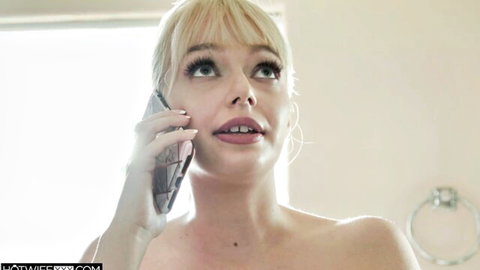 Blonde babe topless on phone call with sexy open mouth in bathroom