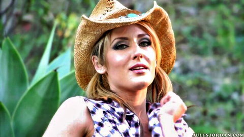 Blonde MILF in cowboy hat teases huge tits with deep cleavage in checkered top