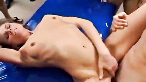 Naked brunette gets trimmed pussy fingered intensely by guy on blue mat in group scene