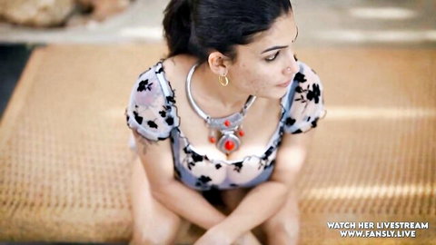 Indian beauty in floral off-shoulder top flaunting cleavage outdoors