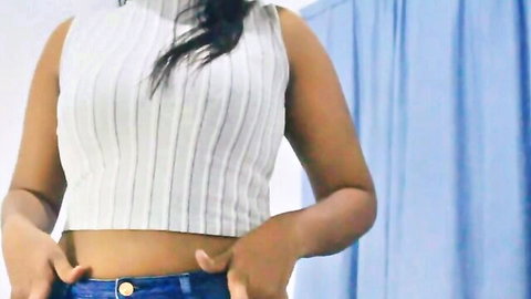 Insatiable Indian woman in cropped white top and jeans posing seductively