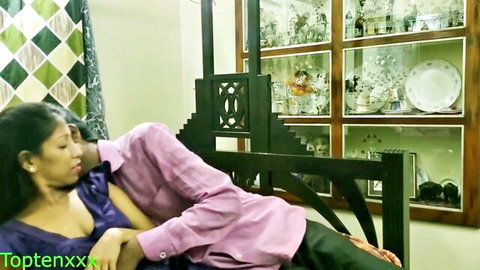 Indian couple intimately cuddling, wife in low-cut purple top showing cleavage