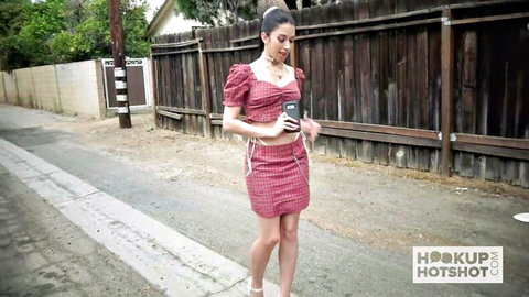 Alex Coal in sexy red checkered crop top and mini skirt on street, holding phone