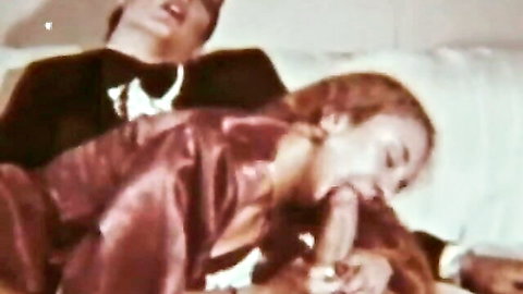 Retro redhead in shiny dress giving blowjob in vintage porn compilation